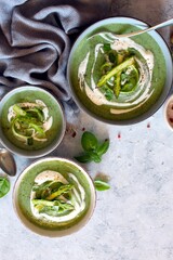 Obraz premium Asparagus and potato cream soup on light background. Top view with copy space. Healthy food.