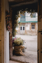 Door with a textile bag with plants decorating the entrance.