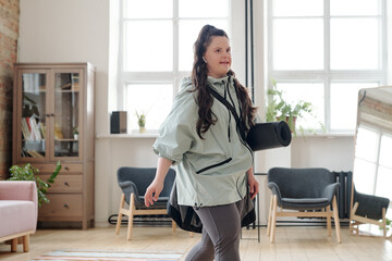 Girl with down syndrome going to yoga training in fitness center