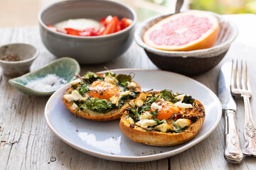 Eggs baked inside brioche bun with watercress and feta