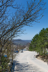 Picturesque mountain spring landscape with sea views. A winding road in the mountains, Crimea. Travel and vacation concept.