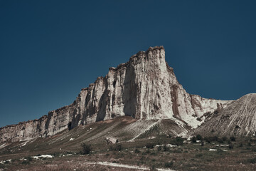 White rock mountain on a background of blue sky