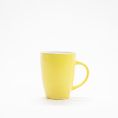 yellow coffee cup in a white background