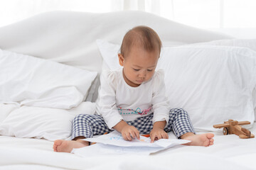 Little toddler child drawing at home, during pandemic Covid-19 quarantine. Happy creative child, homeschooling and home daycare. Weekend leisure activities concept