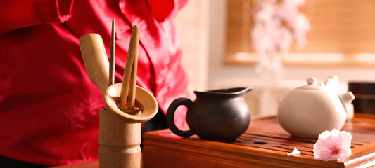 Traditional tea ceremony. Master near tools and tray, closeup