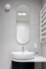Modern bathroom with oval mirror