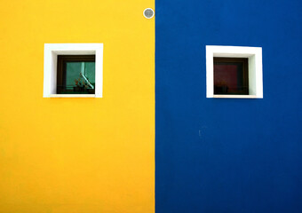 yellow wall with blue windows