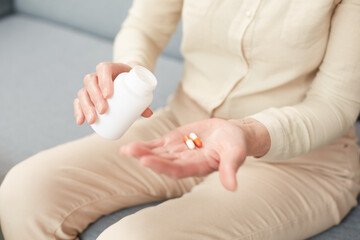 Pills in a senior's hands. Painful old age. Caring for the health of the elderly