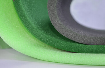 three light green and gray curved soft foam sheet materials