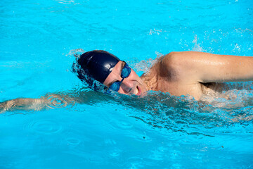 an adult, former swimmer, trains in a public swimming pool