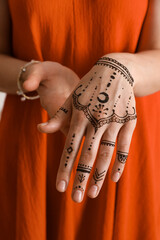 Woman with henna tattoo on hand, closeup. Traditional mehndi ornament