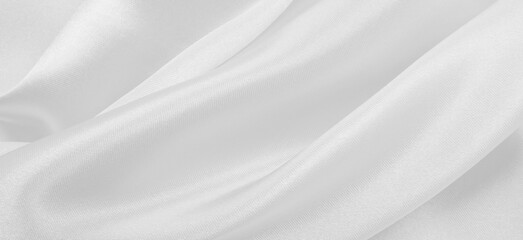 Obraz premium Smooth elegant white silk or satin luxury cloth texture as wedding background. Luxurious background design