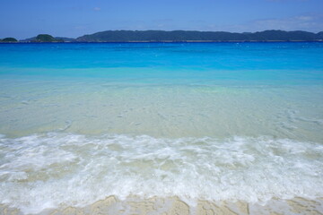 Beautiful summer scenery. calm waves on the blue water. Furuzamami Beach in Zamami island, Okinawa, Japan. Closeup - 日本 沖縄 座間味島 古座間味ビーチ 青い海