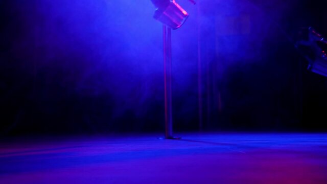 Slender legs of pole dancer in high heels, close-up.