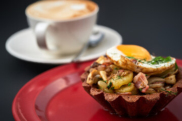 basket with bacon fried potatoes and egg and a cup of coffee break