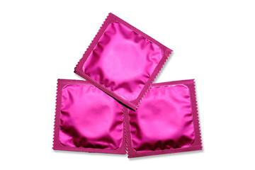 Close up of a pink condom on white background, wrappers in square and rectangle packaging on white background - Clipping Path. - Powered by Adobe