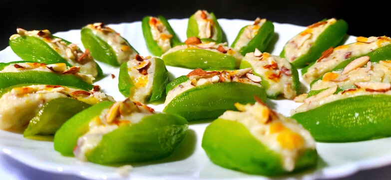 Pointed gourd sweets isolated in black background.