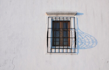 Pregnant window on white wall, Evora, Portugal.