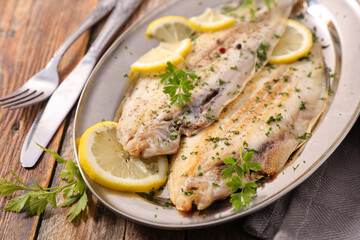 baked fish fillet with lemon, butter and parsley