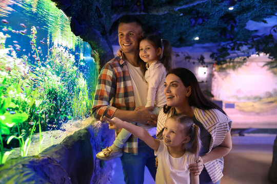 Happy family near aquarium in oceanarium. Spending time together