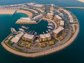 An Aerial shot of circular Marina where many yachts are docked