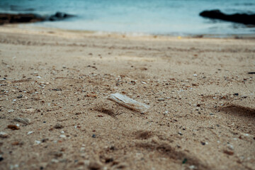Plastic trash mixed with sand found in the beach.