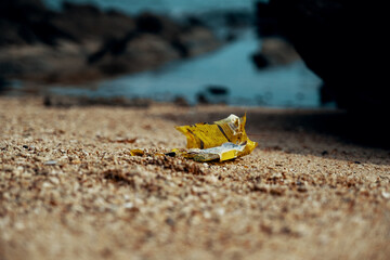 Fototapeta na wymiar Yellow plastic garbage found in a beach mixed with sand.