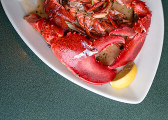 big cooked crabs on white triangular plate