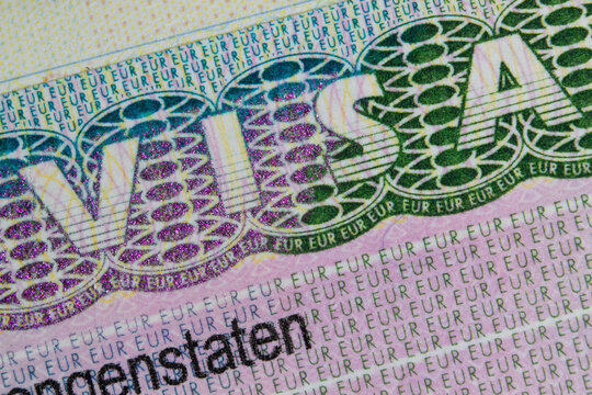 Schengen European visa stamp in the passport. Clouse-Up. Fragment of Schengen visa in the passport