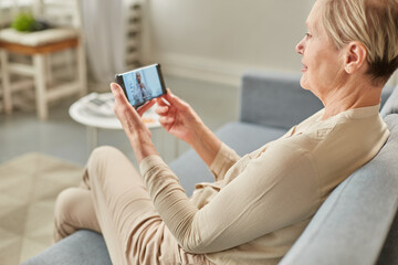 Sick woman during a video call with a doctor. Side view of patient talking during conference call with his doctor while at home
