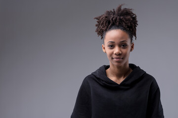 Studio portrait of a trendy young Black woman in hoodie