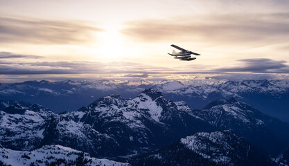 Fototapeta na wymiar Airplane flying near the Beautiful Canadian Mountain Nature Landscape. Adventure Composite. Dramatic Sunset Sky. Background from near Vancouver, British Columbia, Canada.