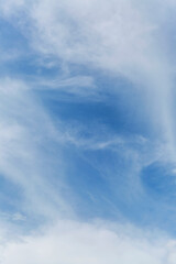 Blue cloudy sky on a clear sunny day. Background. Space for text. Vertical.