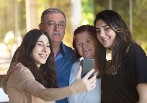 parents and daughters. happy fathers day concept. happy family selfie with phone.