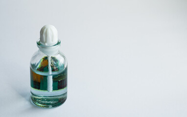 transparent glass bottle for aroma oil with lid on a white background. horizontal image.