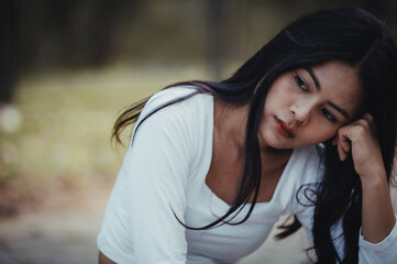 Fototapeta premium Beautiful thai woman very sad from unrequited love,She rethink and think over about love,vintage style,dark tone,broken heart,asian girl