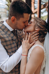 Walk of the bride and groom in the greenhouse. Beautiful summer photo session in nature.