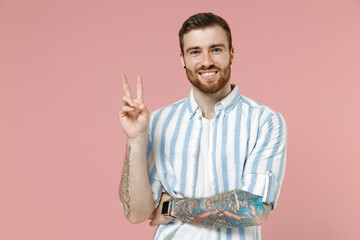 Young happy cheerful smiling friendly caucasian unshaven man 20s in blue striped shirt white...