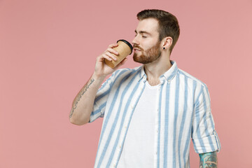 Young happy caucasian unshaven man 20s wearing blue striped shirt hold takeaway delivery craft...