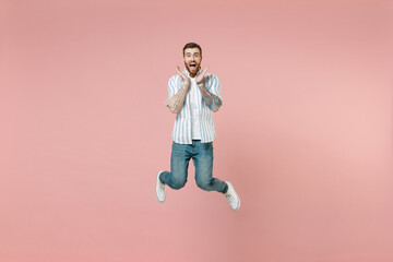 Full length young overjoyed surprised excited unshaven man 20s wear blue striped shirt white...