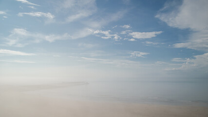 Fototapeta na wymiar Sunny, hot summer day, but cold water. Fog on the beach, Pavilosta, Latvia.