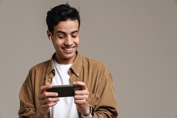 Smiling young brunette man in t-shirt standing