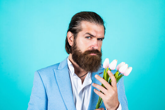 he likes it. bearded man in formalwear with tulip flowers. elegant businessman wear elegant apparel for formal event. spring present. true gentleman with bouquet. love date concept