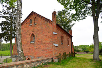Fototapeta premium General view and close-ups of architectural details of the funeral chapel at the Catholic Church of the Assumption of the Blessed Virgin Mary, in the town of Galiny, warmi, Poland.