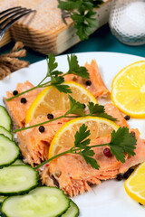 Trout baked in foil with lemon on the table