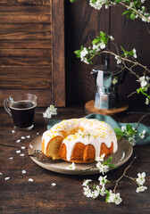 Homemade lemon bundt cake decorated with white glaze and zest