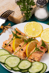 Trout baked in foil with lemon on the table