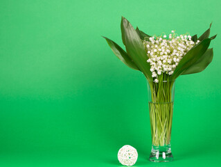 Bouquet of fresh beautiful lilies of the valley in a glass vase