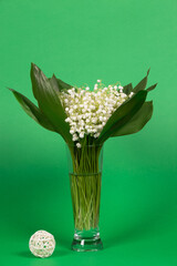 Bouquet of fresh beautiful lilies of the valley in a glass vase