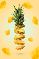 Flying fresh pineapple slices isolated on yellow background